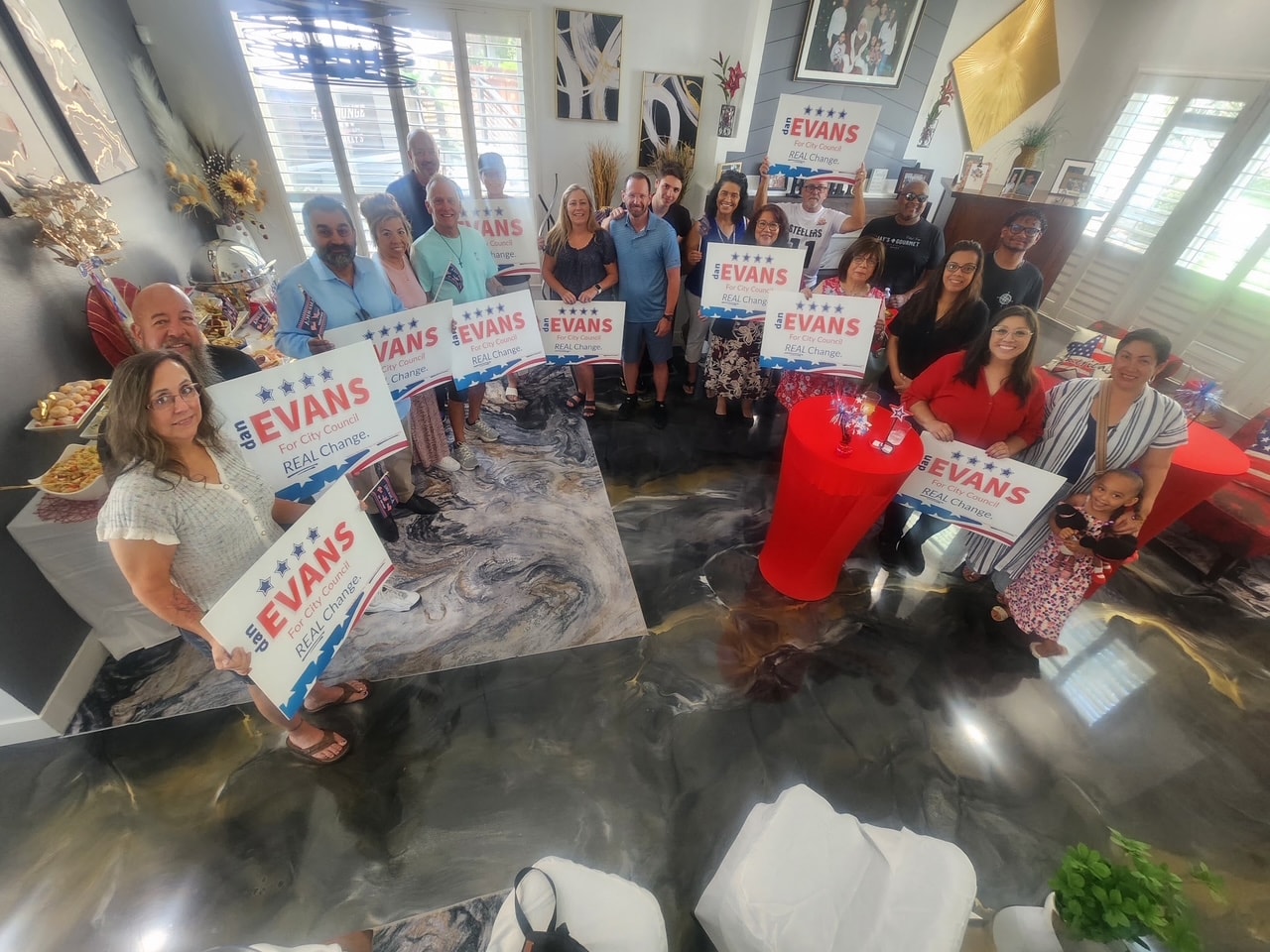 Dan Evans campaign kickoff with supporters holding signs