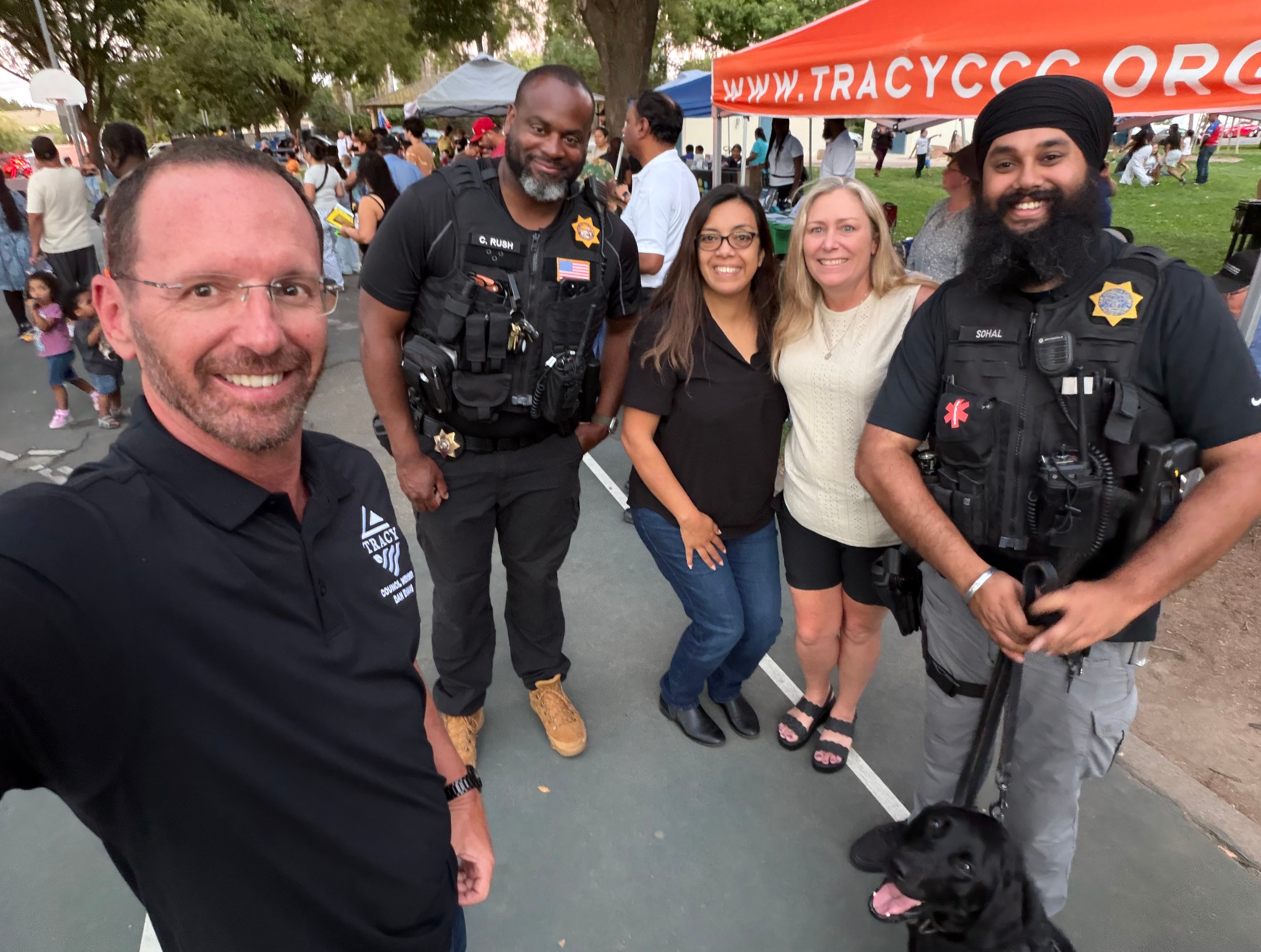 Dan Evans with Tracy police officers at a community event