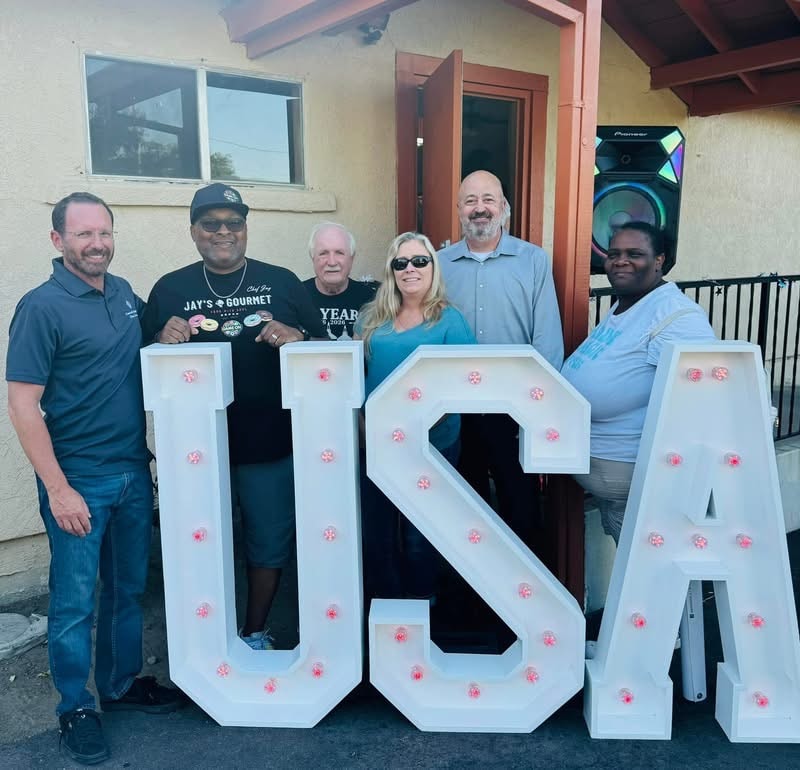 Dan Evans with community members at a USA celebration event